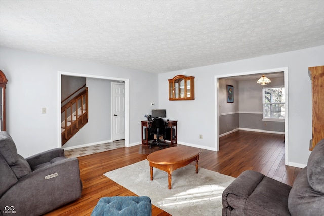 living room featuring dark hardwood / wood-style floors and a textured ceiling