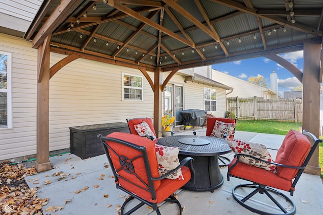 view of patio with a gazebo, area for grilling, and a fire pit