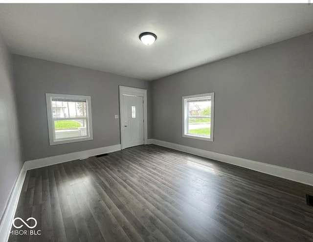 spare room with dark wood-type flooring