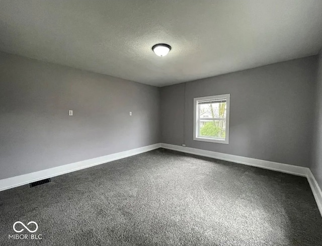 spare room with carpet floors and a textured ceiling