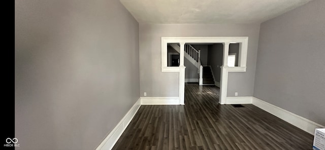 empty room with dark hardwood / wood-style floors