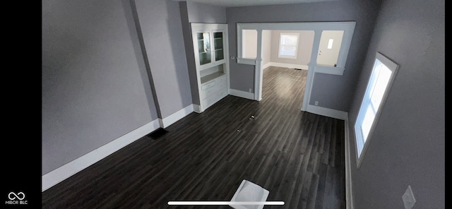 hallway with dark hardwood / wood-style floors