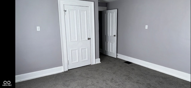 unfurnished bedroom featuring dark colored carpet