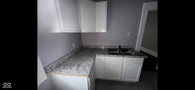 kitchen featuring sink and white cabinetry