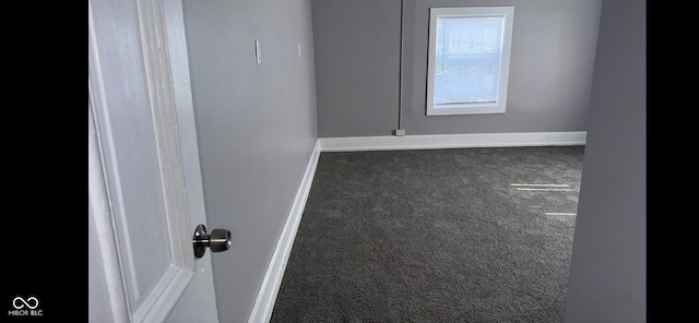 empty room with dark colored carpet