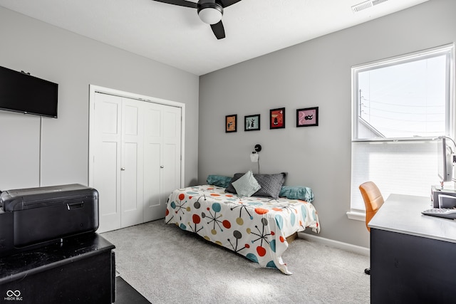 carpeted bedroom featuring a closet and ceiling fan