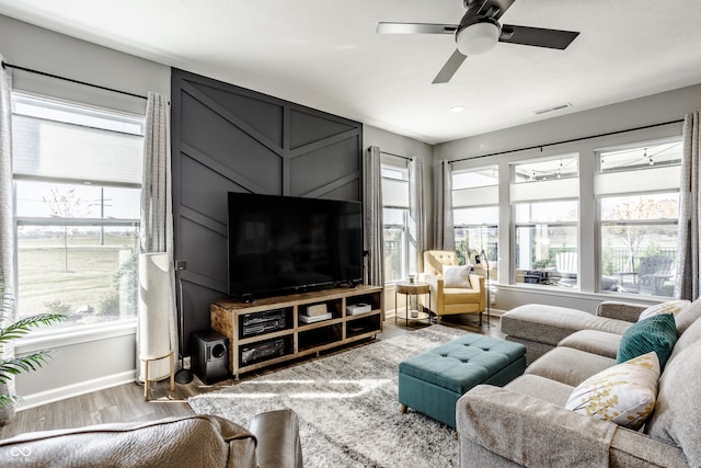 living room with wood-type flooring and ceiling fan