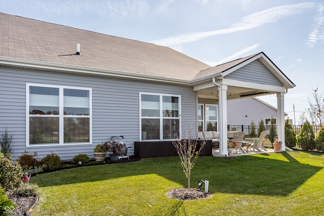 rear view of property with a patio area, a lawn, and ceiling fan