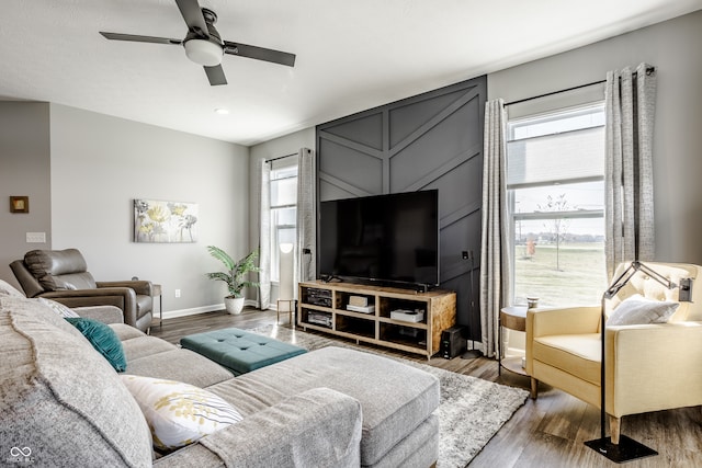 living room featuring ceiling fan, hardwood / wood-style flooring, and a wealth of natural light