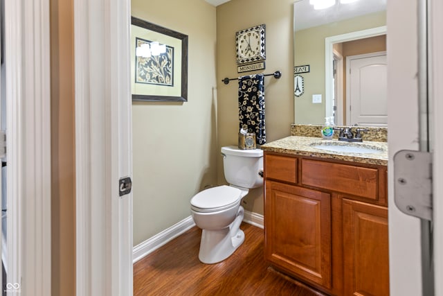 bathroom featuring hardwood / wood-style floors, vanity, and toilet