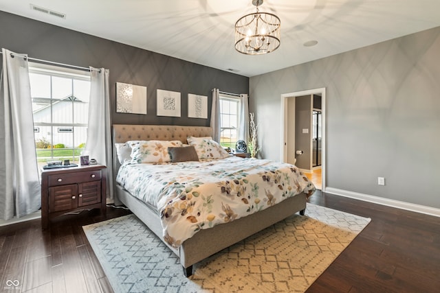 bedroom with dark wood-type flooring and a chandelier