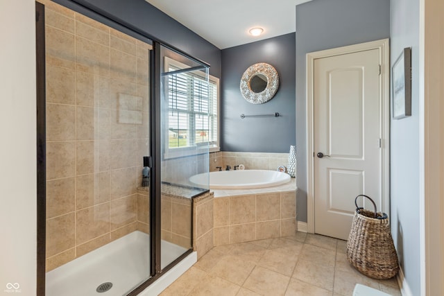 bathroom featuring tile patterned floors and separate shower and tub