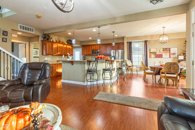 living room with an inviting chandelier and hardwood / wood-style floors