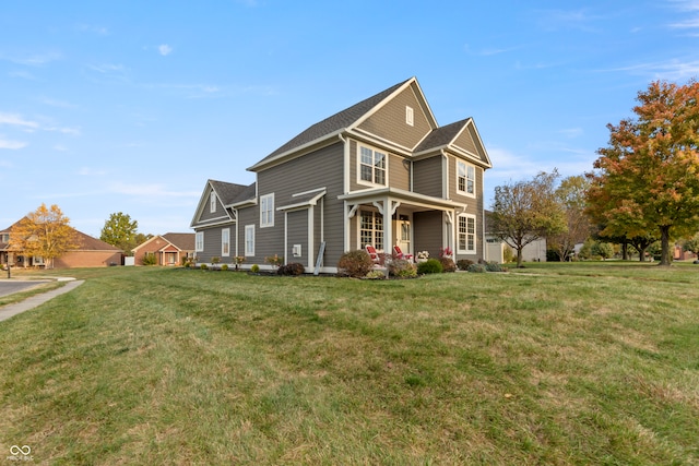 view of front of house featuring a front lawn and covered porch