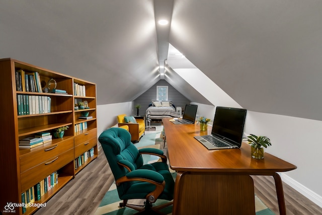 office space featuring hardwood / wood-style floors and vaulted ceiling