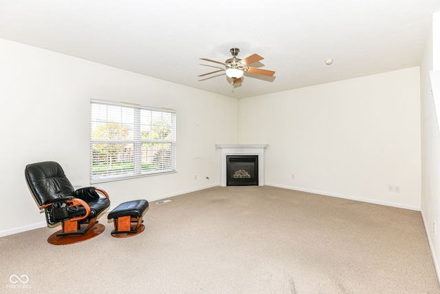 living area featuring ceiling fan and carpet floors