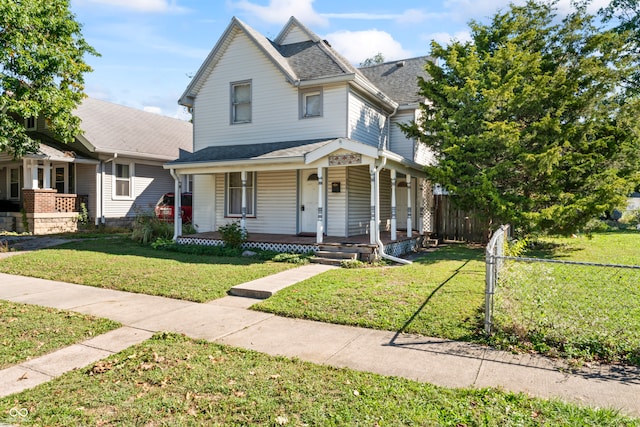 view of front of home with covered porch and a front yard