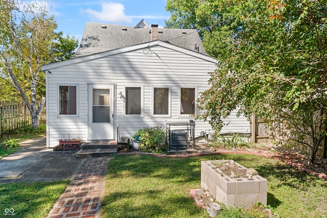 back of property featuring central air condition unit, a yard, and a patio