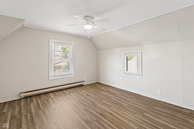 additional living space with ceiling fan, baseboard heating, lofted ceiling, and hardwood / wood-style flooring