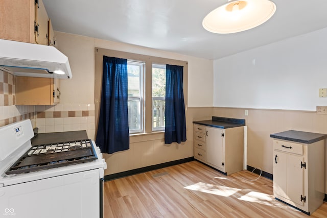 kitchen featuring white range with gas stovetop and light hardwood / wood-style flooring