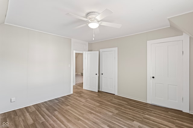 unfurnished bedroom with hardwood / wood-style floors and ceiling fan