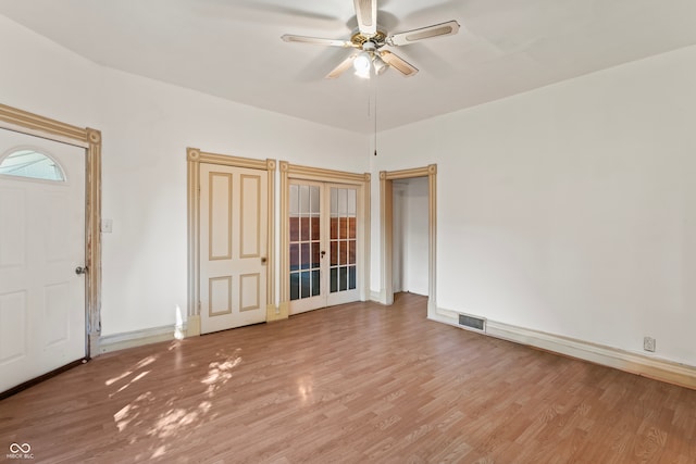 spare room with ceiling fan and hardwood / wood-style flooring