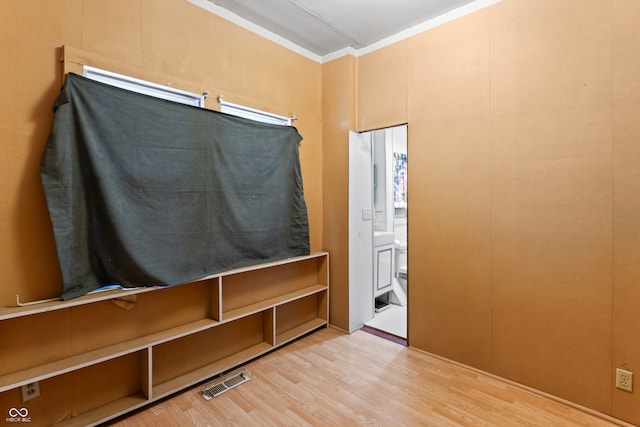 interior space with hardwood / wood-style flooring and crown molding