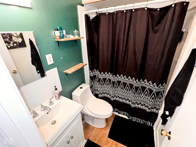 bathroom featuring a shower with shower curtain, backsplash, vanity, wood-type flooring, and toilet