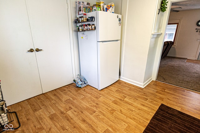 kitchen featuring white fridge and light hardwood / wood-style flooring