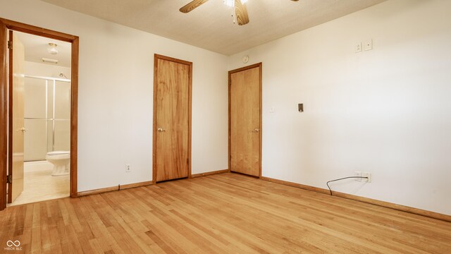5861 S 100 W, Fountaintown, IN 46130 - unfurnished bedroom with light wood-type flooring, baseboards, ensuite bathroom, and a ceiling fan