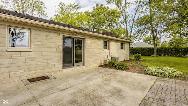 5861 S 100 W, Fountaintown, IN 46130 - rear view of property featuring stone siding, a patio area, a yard, and central AC unit