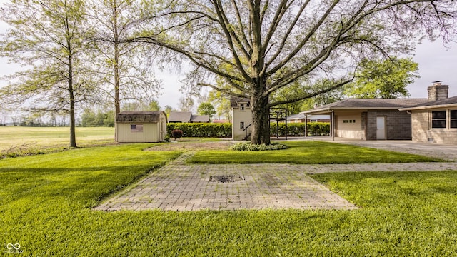 5861 S 100 W, Fountaintown, IN 46130 - view of grassy yard with a shed, a garage, an outdoor structure, and driveway