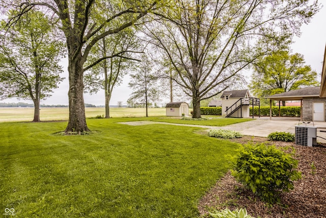 5861 S 100 W, Fountaintown, IN 46130 - view of green lawn featuring a storage shed, an outdoor structure, stairway, and a carport