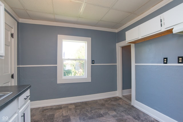 kitchen with ornamental molding, white cabinets, and a paneled ceiling