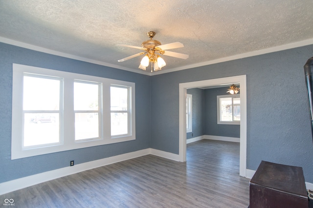 unfurnished room featuring ceiling fan, crown molding, a textured ceiling, and dark hardwood / wood-style flooring