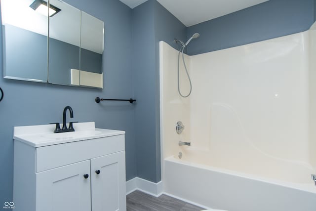 bathroom featuring vanity, shower / bathing tub combination, and hardwood / wood-style flooring