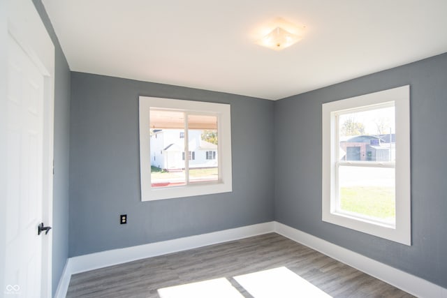 empty room featuring hardwood / wood-style flooring and a healthy amount of sunlight