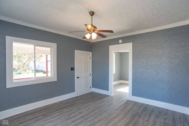 unfurnished room with crown molding, wood-type flooring, a textured ceiling, and ceiling fan