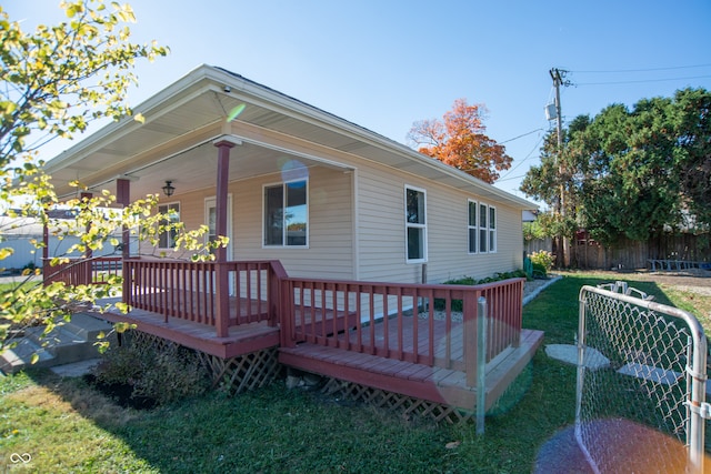 back of house with a yard and a deck