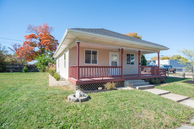 bungalow-style home with a front yard and a deck