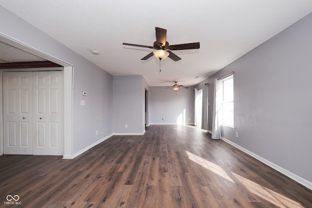 spare room with dark wood-type flooring, a textured ceiling, and ceiling fan