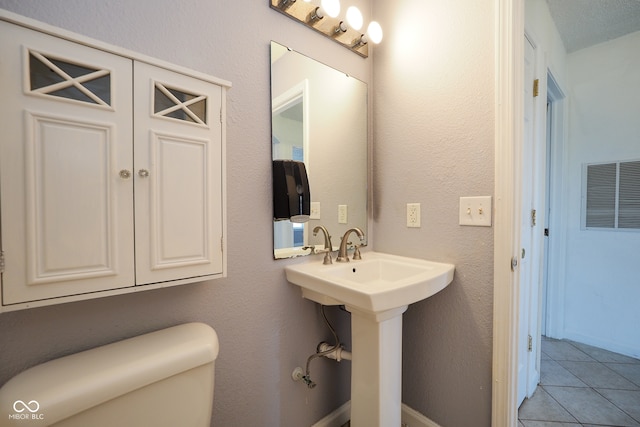 bathroom featuring toilet and tile patterned floors