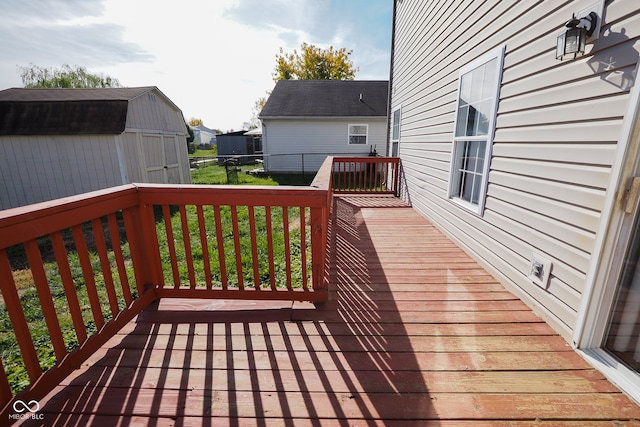 wooden deck with a storage shed