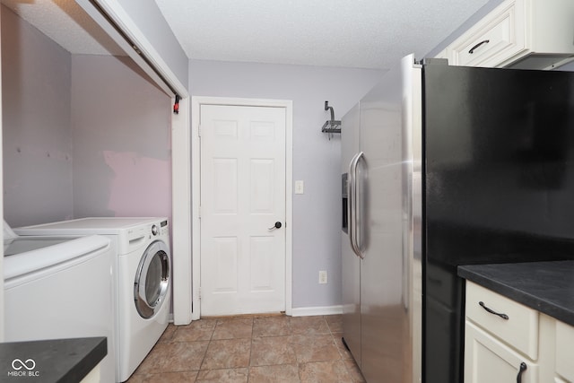 washroom featuring washer and clothes dryer and a textured ceiling