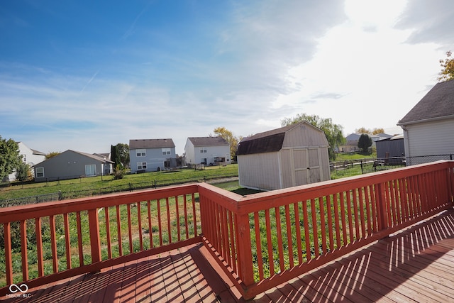 deck with a storage unit and a yard