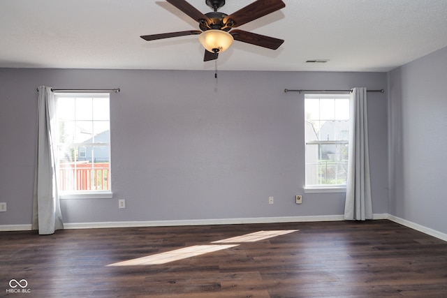 spare room with dark wood-type flooring, ceiling fan, and a textured ceiling