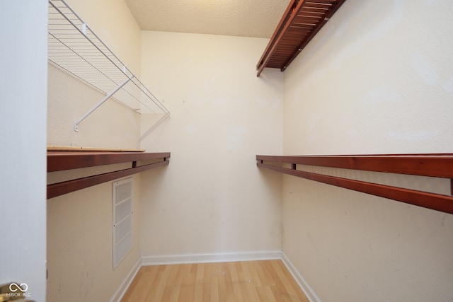 walk in closet featuring wood-type flooring