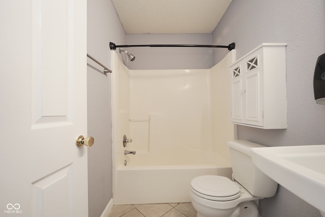 bathroom with toilet, a textured ceiling, washtub / shower combination, and tile patterned flooring