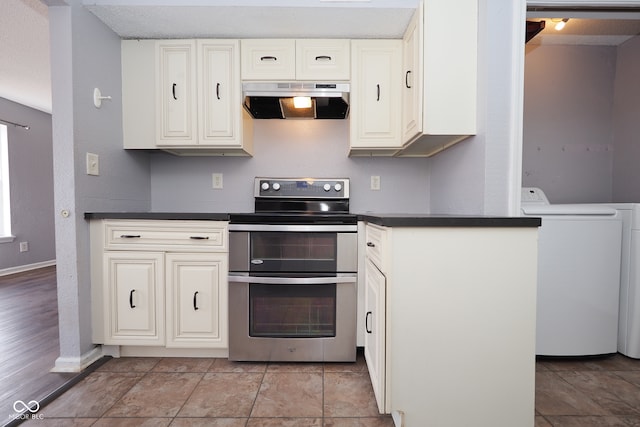 kitchen with washer / dryer, light hardwood / wood-style flooring, ventilation hood, and stainless steel electric range oven