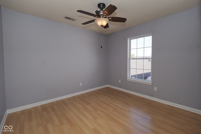 unfurnished room with light hardwood / wood-style flooring, a textured ceiling, and ceiling fan